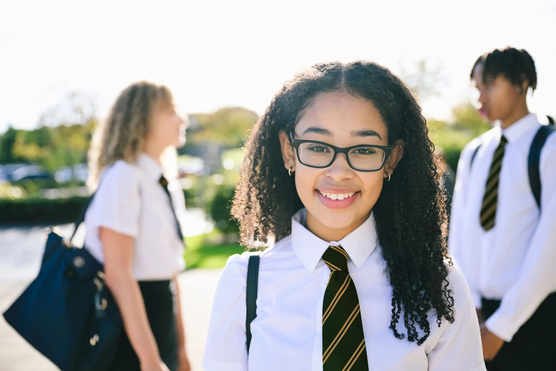 A confident Vaughan College student smiling toward the camera in uniform