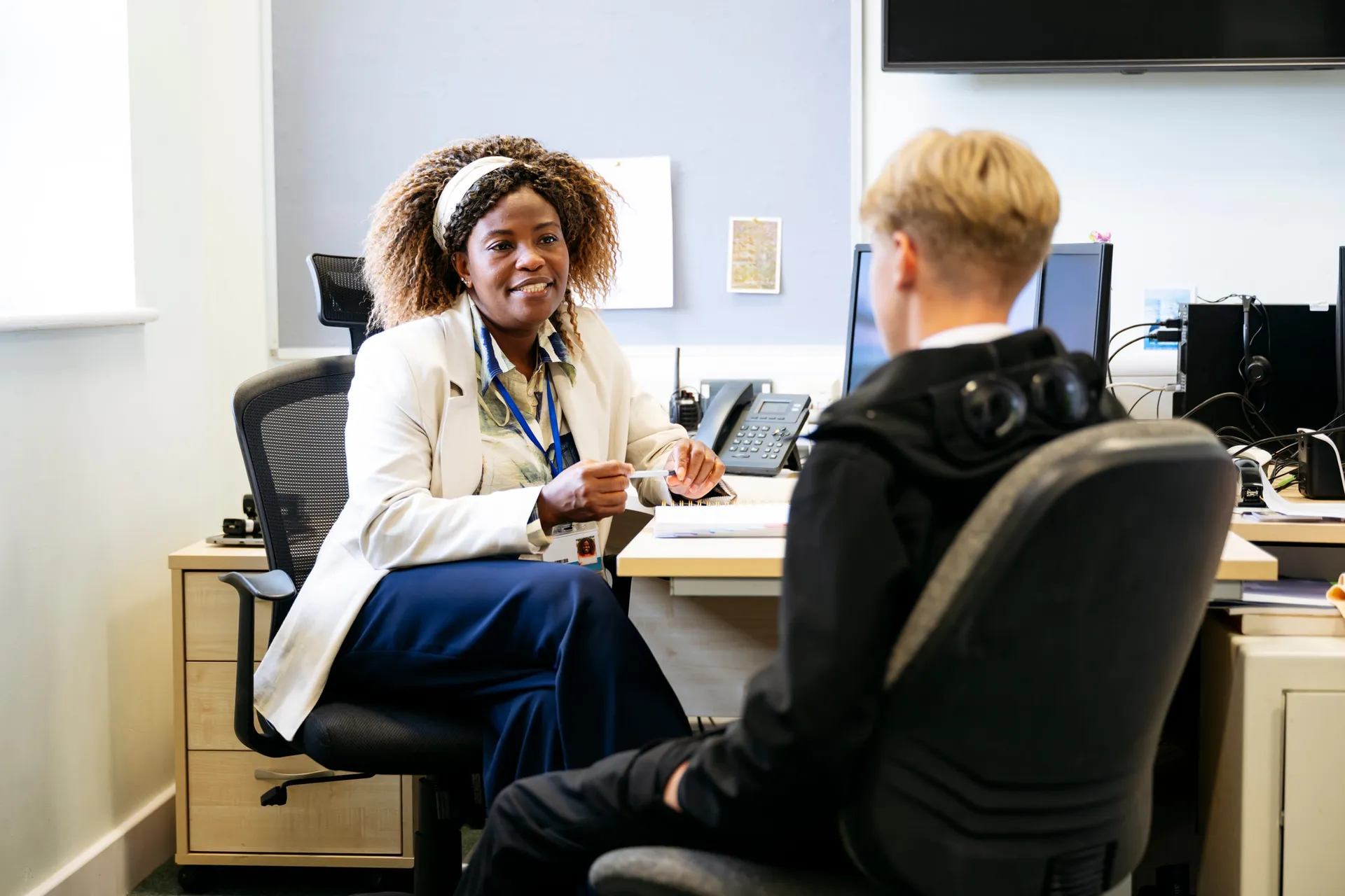 A Vaughan College staff member meeting with a student in a campus office