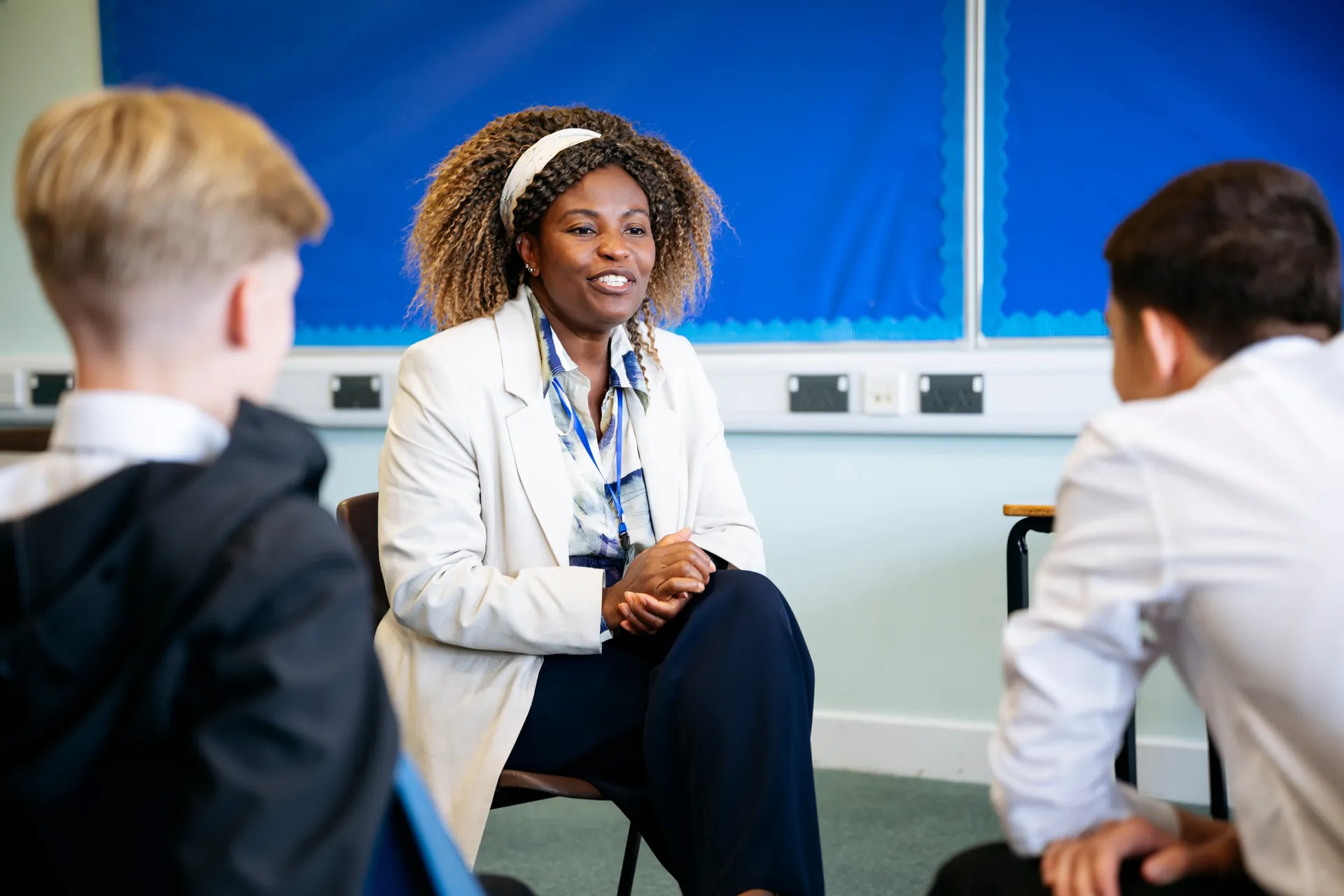 A Vaughan College teacher in discussion with a small group of students
