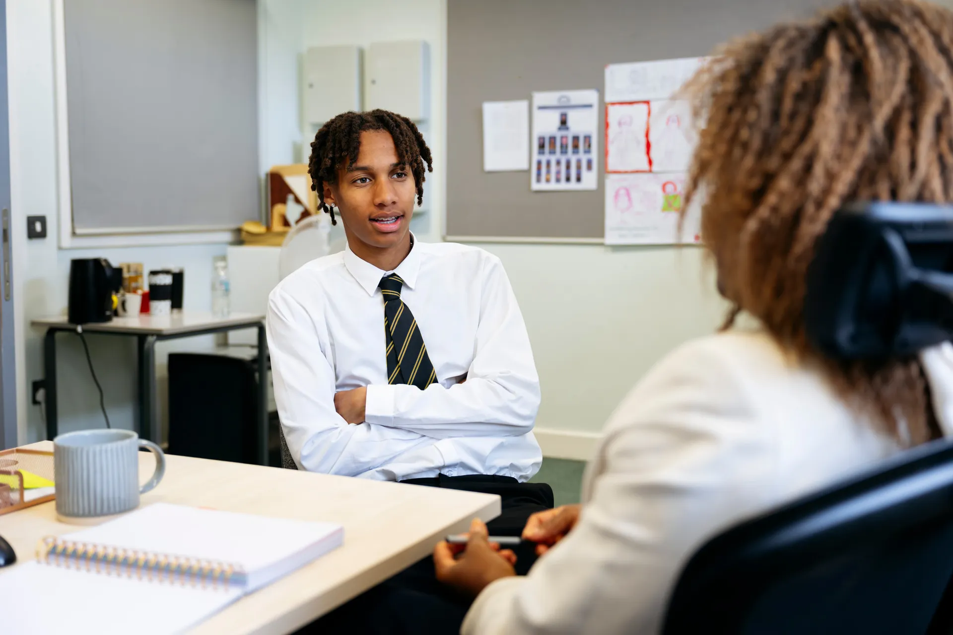 A Vaughan College teacher explaining a concept to an attentive student